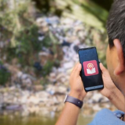 A young person using the TagMe app to map solid waste. (illustration)
