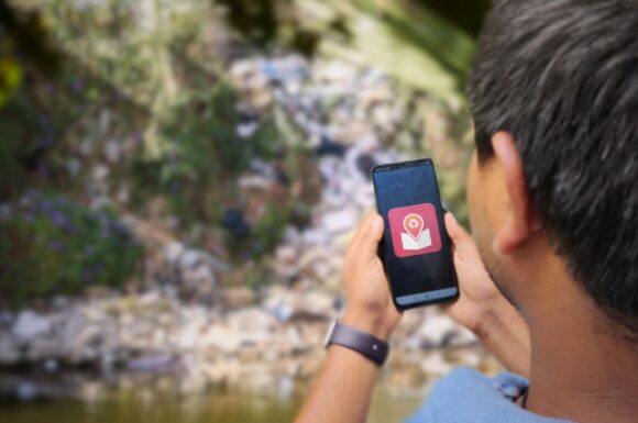 A young person using the TagMe app to map solid waste. (illustration)